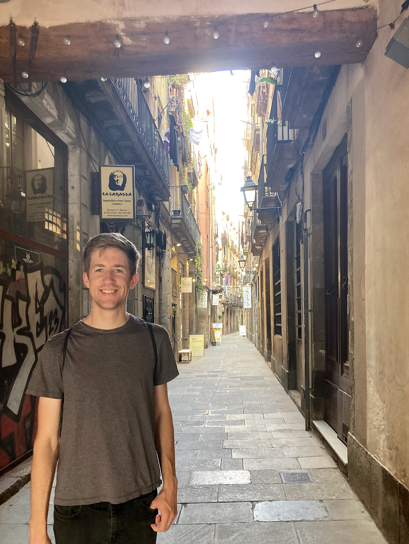 Person standing in a historic stone alleyway, representing the exploration of historical places